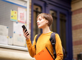 Normal_female-student-standing-in-city-looking-at-mobile-2023-11-27-04-49-43-utc